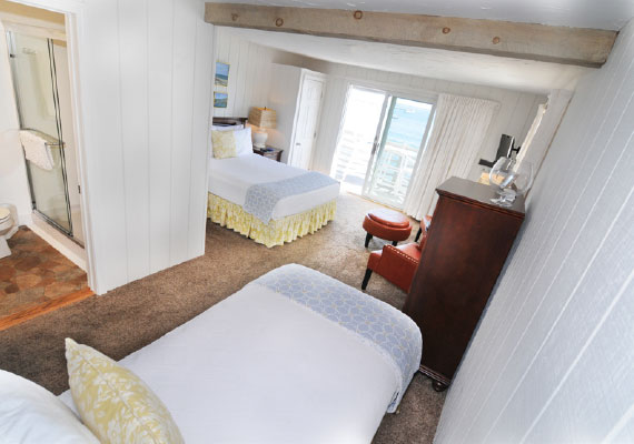 Room Layout: 1 queen bed and 1 twin bed. Located on the second level with a harbor view and outdoor waterfront seating, air conditioning and heating with in-room controls, insuite full bath, complimentary bath robes, morning coffee service, dry bar with refrigerator, WiFi, iHome, Comcast TV/DVD. Every room with a view.